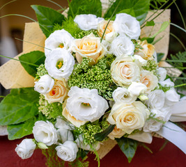 Beautiful bouquet of fresh rose flower and eustoma in cream and white colors. Floral backdrop