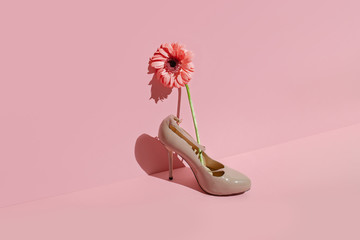 Women's shoes with flowers on a pastel background. Creative concept of fresh smell in shoes, healthy feet, summer sales.