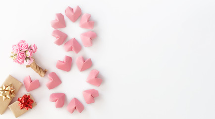 rose pink color paper hearts shape figure eight 8 on white lilac background	
