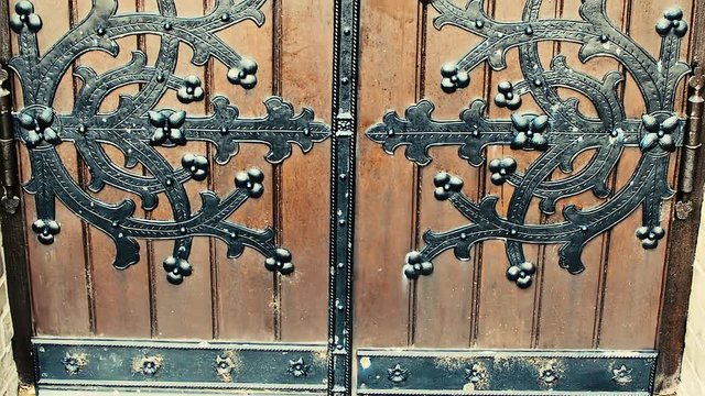 Metal made ornamental decoration at wooden entrance door.