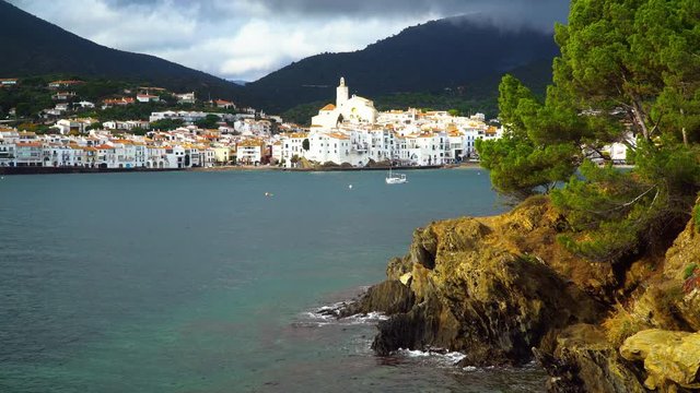 Cadaqu&eacute;s, Catalonia / Spain - November 30th, 2019: Skyline of the old village with an old Mediterranean fishing boat
