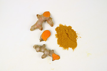 Turmeric extract powder and turmeric stalks on a white background are used as a tonic for the body and food ingredients. Turmeric helps to treat gastritis.