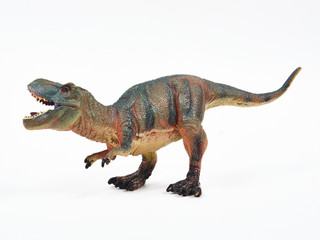 Tyrannosaur rubber toy isolated on white © Y