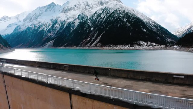 A Person Is Skateboarding On The Dam Of Schlegeis Stausee, Austria.