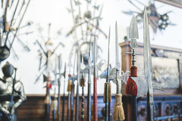 armory room with steel swords collection, shields, spears and medieval weapons