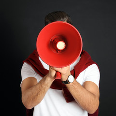 Man with red megaphone on black background