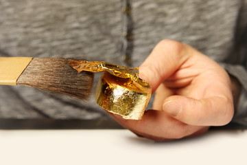 Artwork of gilding - covering an object with plate metal gold