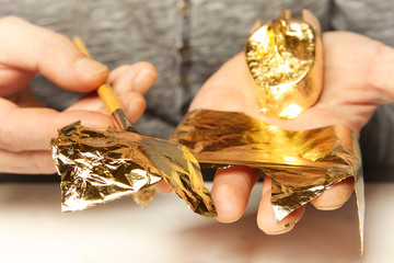 Artwork of gilding - covering an object with plate metal gold