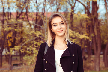 Young pretty woman in the autumn park