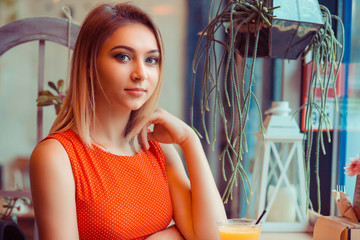 Beauty woman with perfect smile looking at camera at home in a coffee shop