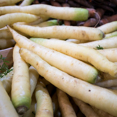 carrots: purple, yellow and orange for sale on a counter in the Borough Market