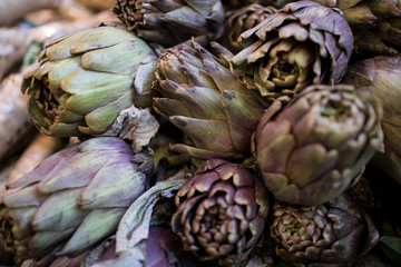 Background of beautiful fresh green artichokes on a Mahan Yehuda market counter