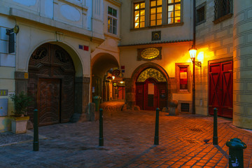 Narrow night streets lit by old lanterns in the center of Prague