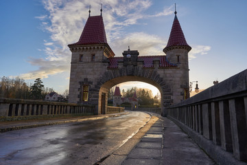 Fototapeta na wymiar Fortified gate with two towers on the top of Beautiful historical dam Les kralovstvi in Czech Republic, build as a barrier against flooding and make electric power on biggest czech river Elbe.