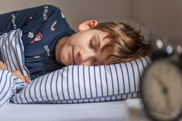 Obraz na płótnie Canvas Cute boy sleeping in a bed.