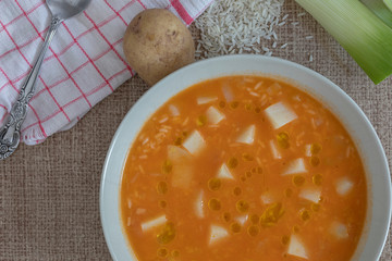 A plate with potatoes and rice soup.