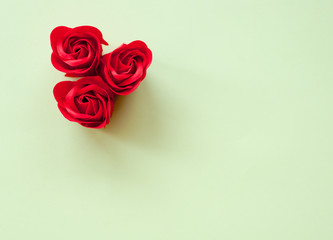 Red roses on a green background. Festive background for Valentine's day