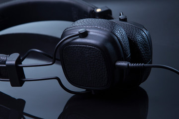 black headphones on a glossy table close-up