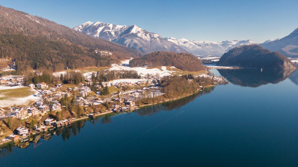 Fototapeta na wymiar Aerial view on houses near water, small alpine village St. Wolfgang and Wolfgangsee Lake in Austria