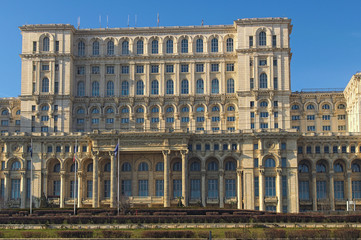 Main part of huge building of the Palace of the Parliament in Bucharest. Building against blue sky. Winter cool day. The largest building in Europe. Romania