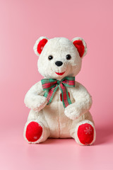 soft toy white teddy bear on a pink background