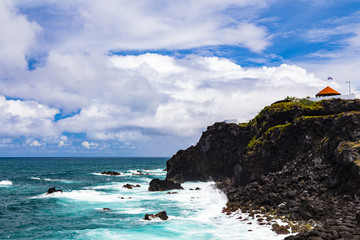 View on the volcanic black cliff in Atlantic Ocean, Ribeira Grande, Sao Miguel, Azores