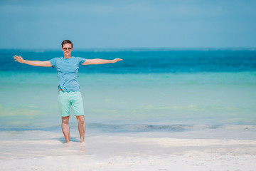 Fototapeta na wymiar Young man on the white tropical beach