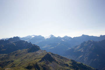 View at the swiss alps in summer with snow covered mountains in the background