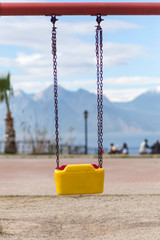 Empty swing with yellow and red colors