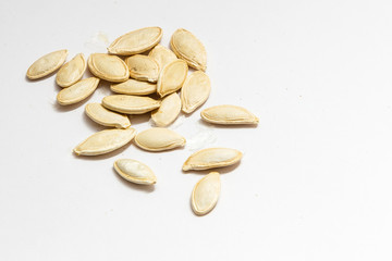 Heap of pumpkin seeds isolated on white background