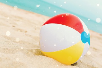 Colorful beach ball in the beach sand