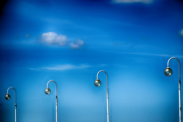  blue sky with white clouds and lanterns on a warm sunny day