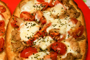 treviso, italy, 01/03/2020 , Bruschetta with cheese, tomatoes and tuna fish served as dinner in an italian house.