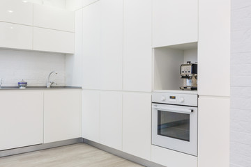 Modern white kitchen without handles