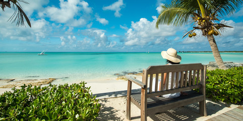 Woman on a bench, Caribbean lagoon Bahamas