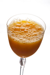 fresh orange juice in a glass on a white background