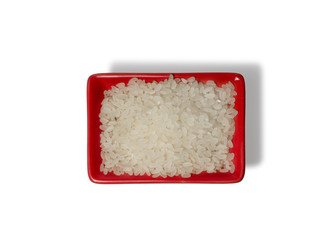 Rice in a red rectangular saucer isolated on white background. The view from above