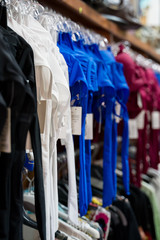 Many female swimsuits in supermarket. Close-up view.