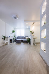 Interior design with couch, colorful cushions and lamp