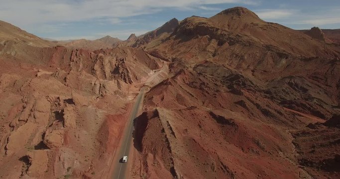 Drone footage of car moving on road amidst rocky mountains, High Atlas, Morocco