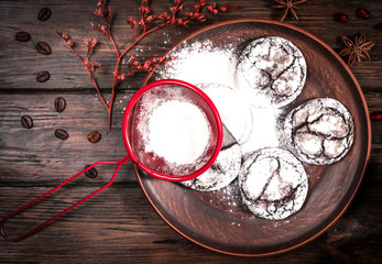 powder cookies and sieve on a wooden background