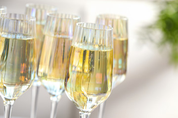 Glasses of champagne on blurred background, closeup view