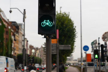 Green traffic light for bikes and one biker goes on the lane
