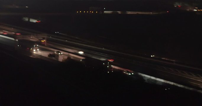 Drone footage of vehicles moving on highway in city at night, Baden-Wuerttemberg, Germany