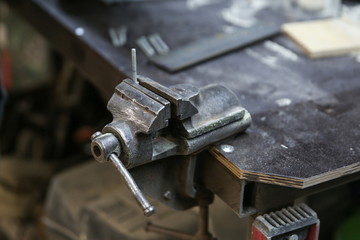 small vise on the workbench close up