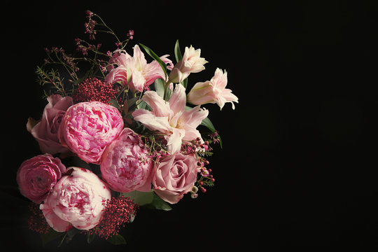 Beautiful bouquet of different flowers on black background. Floral card design with dark vintage effect © New Africa