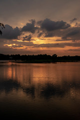 Obraz na płótnie Canvas orange sunset with the sky reflected in the lake in Tissamaharama, Sri Lanka