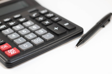 Calculator and pen isolated on white background