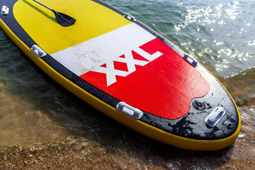 Big paddle standing board on the beach