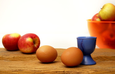 composition of eggs and apples on wood